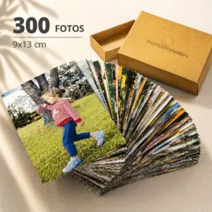 Pack de 300 fotos 9x13 en abanico sobre una mesa con una cajita de carton craft de Fotoimagen al lado